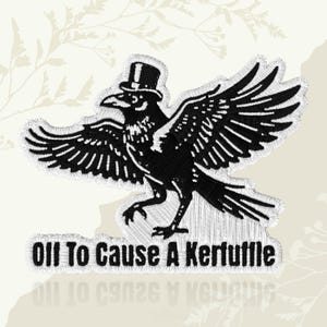 May include: Black embroidered patch featuring a crow wearing a top hat with outstretched wings. The text "Oll To Cause A Kerfuffle" is below the crow. The patch has a white border and is on a cream background.