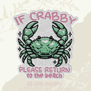 May include: Embroidered patch featuring a green crab with black outlines and claws. The text "IF CRABBY PLEASE RETURN to the beach" is in pink, arched above and below the crab. The patch has a white border and a textured appearance.