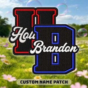 May include: A white ceramic mug with a black handle and the text "But First, Coffee" in a bold, black font. The mug is set against a blurred background. The mug appears to be approximately 10 cm tall.