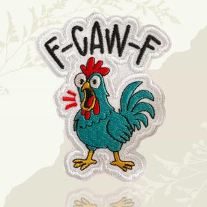 May include: Embroidered patch featuring a cartoon rooster with teal feathers, a red comb and wattle, and yellow feet. The patch has the text "F-CAW-F" in black letters on a white cloud-shaped background. The rooster is depicted with wide eyes and an open beak.