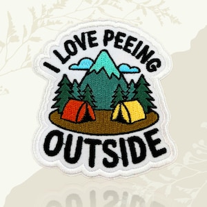 May include: Embroidered patch with the text "I LOVE PEEING OUTSIDE". The patch features a mountain scene with green trees, blue clouds, and two tents in red and yellow. The patch has a white border.