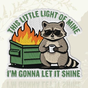 May include: Embroidered patch with a raccoon in sunglasses, holding a mug, beside a dumpster fire. The patch has the text "THIS LITTLE LIGHT OF MINE" and "I'M GONNA LET IT SHINE" in green.