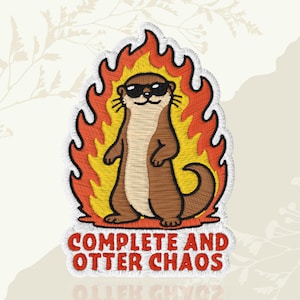 May include: An embroidered patch featuring a brown otter wearing black sunglasses, standing in front of yellow and orange flames. Below the otter, the text "COMPLETE AND OTTER CHAOS" is stitched in red capital letters with a white border.