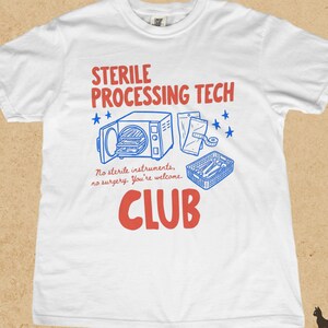 Op de afbeelding: Een wit t-shirt met rode en blauwe grafische tekst die STERILE PROCESSING TECH CLUB en No sterile instruments, no surgery. You're welcome. leest. Het ontwerp bevat illustraties van een autoclaaf, zakjes en een mandje.