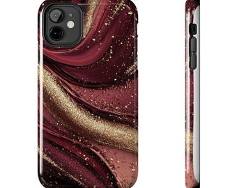 May include: A phone case with a swirling design in shades of burgundy and gold. The case has a glossy finish and a black border. The design features a mix of textures, with glitter-like accents throughout the burgundy and gold pattern.