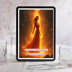 May include: A digital tablet displays a vibrant image of a woman in a flowing orange dress, surrounded by flames. The text on the tablet reads "DIGITAL PRINTABLE NOTEBOOK JOURNAL" and "INSTANT DOWNLOAD". Clear glassware sits on either side.