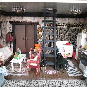 May include: A miniature dollhouse interior with a living room and kitchen. The living room has a floral wallpaper, a red velvet couch, a coffee table, and a lamp. The kitchen has a white refrigerator, a black stove, and a wooden countertop. There is a ladder leading to an upper level.