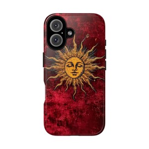 May include: A red phone case featuring a detailed illustration of a sun with a face. The sun is golden yellow with radiating rays, set against a textured, dark red background. The case has a camera cutout and black side buttons.