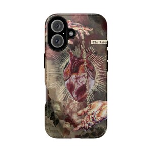 May include: A phone case featuring a detailed illustration of a human heart suspended by a chain between two sets of hands. The design includes a golden sunburst, floral elements, and the text "The Lover".
