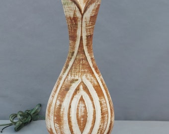 May include: A ceramic table lamp with a white and brown striped design. The lamp has a wide base and a narrow neck with a flower-like opening at the top.