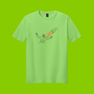 May include: Lime green t-shirt featuring a black line drawing of a person with arms outstretched, pierced by a syringe. The syringe is orange with the word "HOPE" printed on it. The shirt is a solid color.