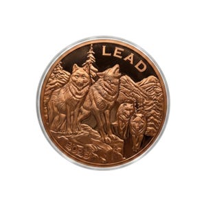 May include: A circular copper-toned coin featuring a relief design of a wolf pack in a forest setting. The word LEAD is embossed at the top, and the year 2026 is embossed at the bottom. The wolves are depicted standing and howling.