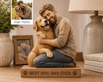 May include: A carved figurine of a man with a beard hugging a golden retriever dog. The man wears a tan shirt and blue pants. They sit on a rectangular wooden base engraved with the text BEST DOG DAD EVER and two paw prints on each side.