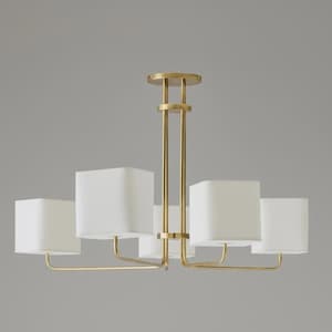 Puede incluir: Un candelabro moderno con una estructura de metal dorado y cinco pantallas cuadradas de tela blanca. La lámpara tiene una columna central con soportes verticales y brazos horizontales que sostienen las pantallas. Diseño minimalista y elegante.
