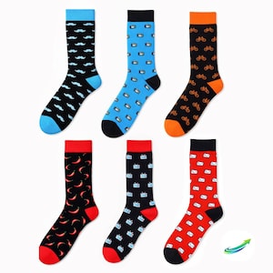 May include: Six pairs of colorful socks with various patterns. Designs include mustaches, cameras, bicycles, chili peppers, televisions, and envelopes. Each pair has a contrasting color on the toe and cuff.