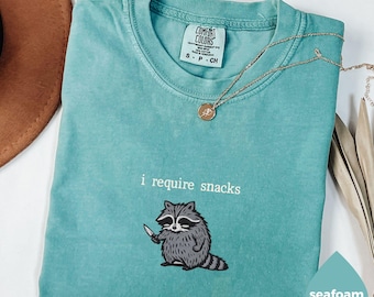 I Require Snacks Raccoon Tee – Funny Comfort Colors® Shirt, Goblincore Animal Lover Gift, Cozy Snack Gremlin Tee