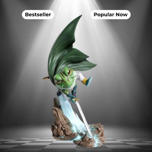 May include: A green frog figurine wearing a flowing dark green cape and white tunic, wielding a silver sword while standing on a rocky base. The figure features red markings on its face and is positioned above text labels reading Bestseller and Popular Now.