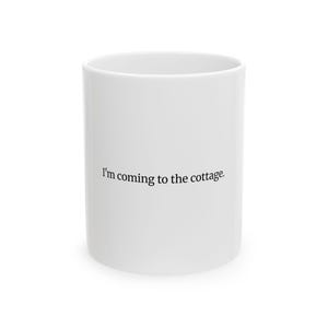 May include: A white ceramic mug with the phrase "I'm coming to the cottage" printed in black. The mug is cylindrical and has a simple, clean design, suitable for hot beverages.