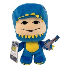 May include: A blue plush toy in a dinosaur costume with yellow accents, holding a toy gun. The toy has a smiling face and a tag that reads "ARSENAL".