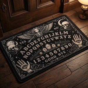 May include: Black rectangular doormat with a Ouija board design. The mat features a detailed illustration with letters, numbers, and symbols, including a skull, angel, and hand with an eye. The words "YES", "NO", and "GOOD BYE" are also visible.