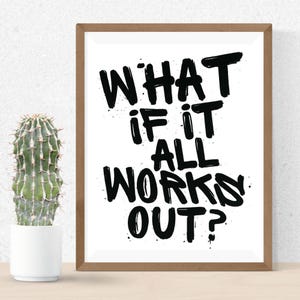 Könnte beinhalten: Gerahmter Druck mit dem Text "WHAT IF IT ALL WORKS OUT?" in fetten schwarzen Buchstaben auf weißem Hintergrund. Der Rahmen ist hellbraun. Links ein Kaktus in einem weißen Topf.
