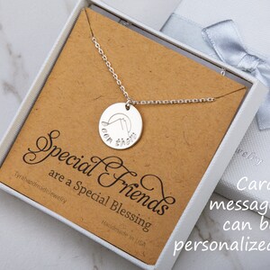May include: A silver necklace with a round pendant that says "Been there" in a cursive font. The necklace is in a white box with a brown card that says "Special Friends are a Special Blessing".