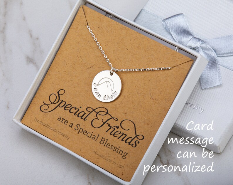 May include: A silver necklace with a round pendant that says "Been there" in a cursive font. The necklace is in a white box with a brown card that says "Special Friends are a Special Blessing".