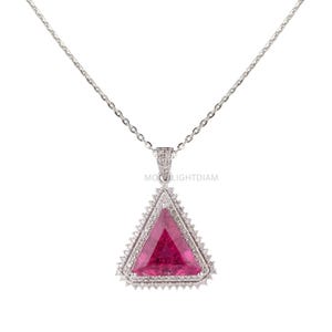 May include: A silver necklace featuring a large, triangular pendant with a vibrant pink gemstone center. The pendant is framed by a double row of small, clear gemstones. The chain is delicate and silver. The text "MOONLIGHTDIAM" is visible on the pendant.
