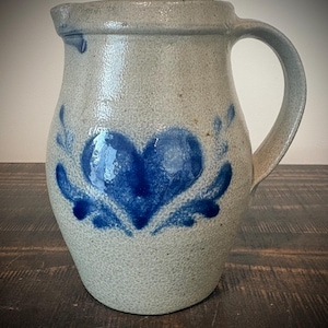 May include: A set of three ceramic mugs with a speckled, matte finish. The mugs are in shades of cream, light gray, and dark gray. Each mug has a simple, minimalist design, perfect for coffee or tea.