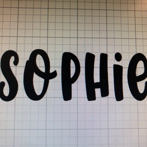 May include: Black cursive text spelling out the name "Sophie". The letters are bold and stand out against a grid background. The design is simple and modern, suitable for various applications.