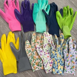 May include: A collection of gardening gloves in various colors and patterns. The gloves include solid colors like pink, purple, green, yellow, and gray, as well as floral and patterned designs. The gloves are made of a flexible material.