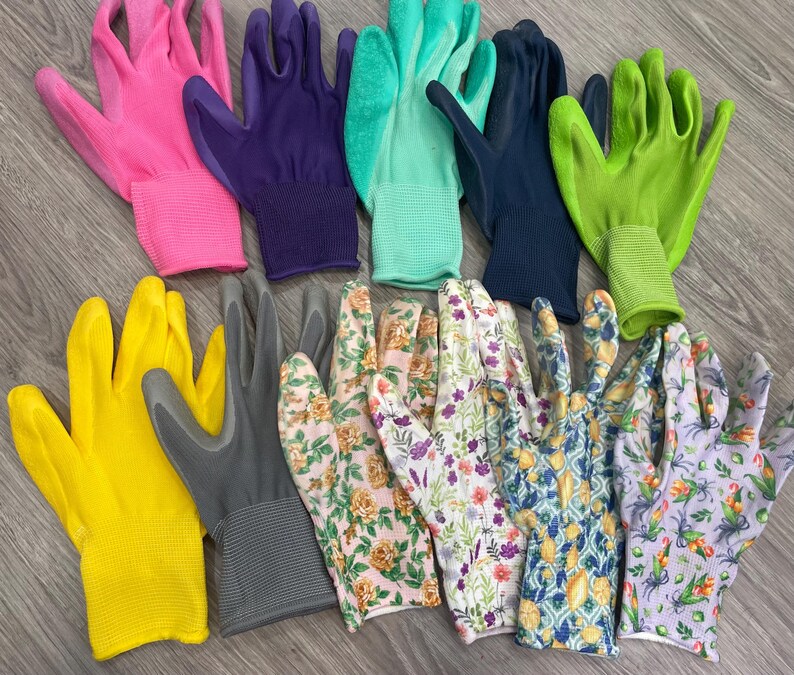 May include: A collection of gardening gloves in various colors and patterns. The gloves include solid colors like pink, purple, green, yellow, and gray, as well as floral and patterned designs. The gloves are made of a flexible material.