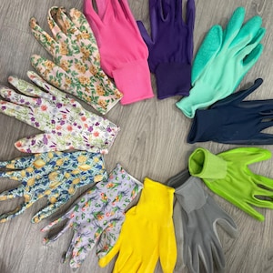 May include: A collection of gardening gloves in various colors and patterns. The gloves include floral prints, solid pink, purple, teal, navy, yellow, and gray. The gloves are arranged in a circular pattern on a wooden surface.