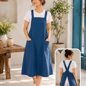 May include: A solid blue pinafore dress featuring a square neckline, wide shoulder straps, and two large front patch pockets. The garment is worn over a plain white short-sleeved t-shirt. An inset shows the back with a crisscross strap design.