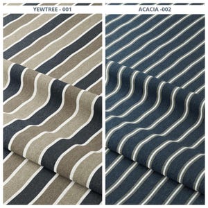 May include: Two fabric samples with diagonal stripes. The left sample, labeled "YEWTREE - 001", features stripes in shades of brown, gray, and white. The right sample, labeled "ACACIA -002", has blue, gray, and white stripes. Both fabrics appear to be textured.
