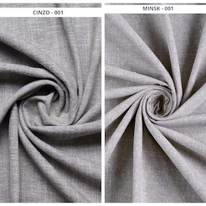 May include: Two grey fabric swatches, labelled "CINZO - 001" and "MINSK - 001." The fabric is tightly woven, possibly linen or a similar material. The fabric is swirled to display the texture and how it drapes. The fabric is a neutral grey.