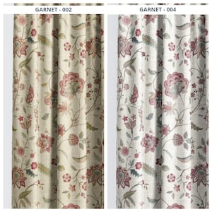 May include: Two floral patterned curtains. The curtains are cream-colored with a repeating pattern of red and green flowers and leaves. The text "GARNET - 002" and "GARNET - 004" is visible at the top of each curtain.