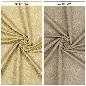 May include: Two swatches of fabric displayed side by side. The left swatch is labeled NARIN-002 and is a bright gold color. The right swatch is labeled NARIN-009 and is a muted beige color. Both fabrics feature a textured, swirling leaf-like pattern.