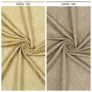 May include: Two fabric samples, one gold and one tan, are displayed. The gold fabric, labeled "NARIN - 002", has a shimmering, textured surface with a subtle pattern. The tan fabric, labeled "NARIN - 009", has a similar texture and pattern.