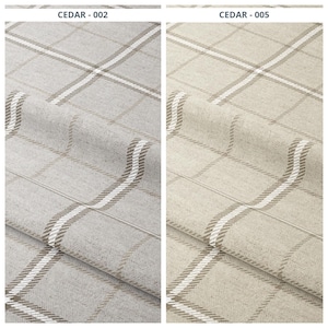 May include: Two fabric samples with a plaid pattern. The sample on the left is gray with white and brown lines. The sample on the right is beige with white and brown lines. The text "CEDAR - 002" and "CEDAR - 005" are at the top.