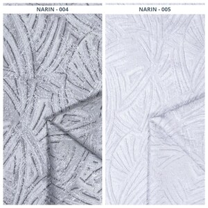 May include: Two fabric samples, labeled NARIN-004 and NARIN-005. NARIN-004 features a gray and white textured pattern with a leaf-like design. NARIN-005 displays a similar pattern in white, with a subtle texture. Both fabrics are folded.