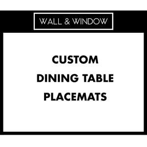 May include: A black and white graphic with the text "WALL & WINDOW" at the top. Below, the words "CUSTOM DINING TABLE PLACEMATS" are displayed in bold, black font against a white background.