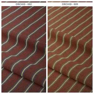 Puede incluir: Dos muestras de tela con rayas verticales. La muestra de la izquierda, etiquetada como "ORCHID - 002", presenta rayas burdeos con finas rayas de acento beige claro y azul marino. La muestra de la derecha, etiquetada como "ORCHID - 009", tiene rayas color óxido con rayas beige claro.