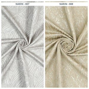 May include: Two fabric samples, one light gray and the other beige, each with a swirling pattern. The fabric has a textured appearance with a repeating leaf-like design. The text "NARIN - 007" and "NARIN - 008" are visible.
