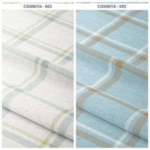 May include: Two fabric samples with a plaid pattern. One is off-white with light green and blue accents, the other is light blue with white and tan accents. The fabric has a textured appearance with a herringbone weave.
