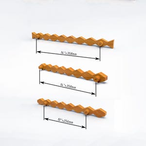 May include: Three light brown wooden drawer pulls with a repeating diamond-shaped geometric pattern. Two pulls measure 14 inches between mounting points, and one pull measures 10 inches between mounting points, as indicated by technical diagrams.