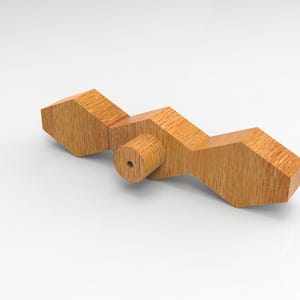 May include: A light brown wooden cabinet pull with a geometric, elongated hexagonal shape. The hardware features a central cylindrical mounting point with a small, centred circular hole for screw attachment, showcasing a natural wood grain texture.