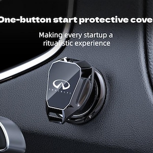 May include: A black, angular protective cover for a car's one-button start ignition, featuring the Infiniti logo in white. The text "One-button start protective cover" and "Making every startup a ritualistic experience" is visible above the device.
