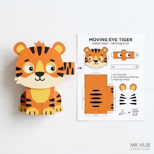 Puede incluir: Un kit de manualidades en papel con un tigre de ojos móviles. Incluye una figura de tigre precortada y una hoja de instrucciones titulada MOVING EYE TIGER PAPER CRAFT - PRINTABLE KIT, que muestra los pasos para cortar, doblar y pegar.