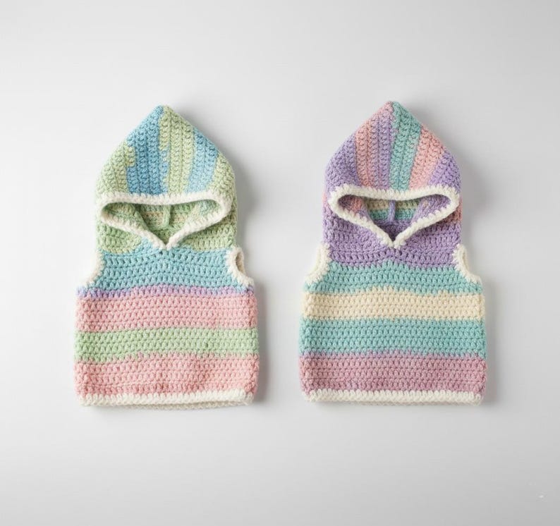 May include: Two pastel-colored crochet hooded vests. One vest features stripes of pink, green, and blue, while the other has purple, blue, and cream stripes. Both vests have a white trim and are displayed on a white background.